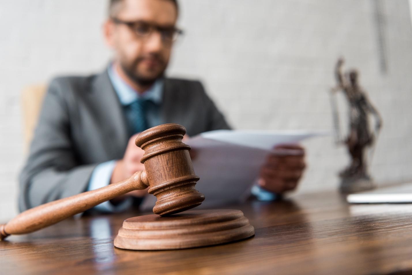 Picture of lawyer with gavel in front 